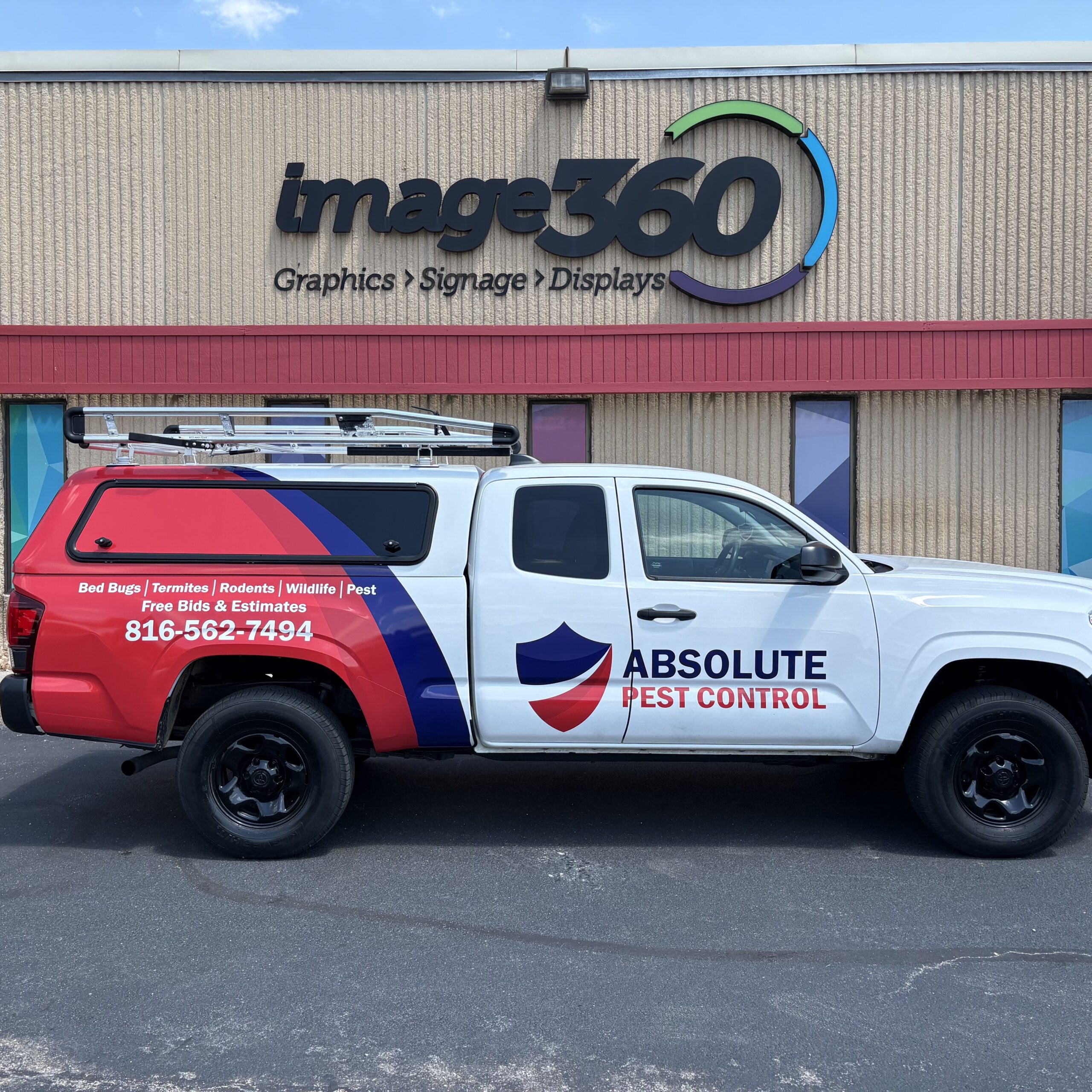 Red, white and blue partial vehicle wrap on an Absolute Pest Control pickup truck in Kansas City