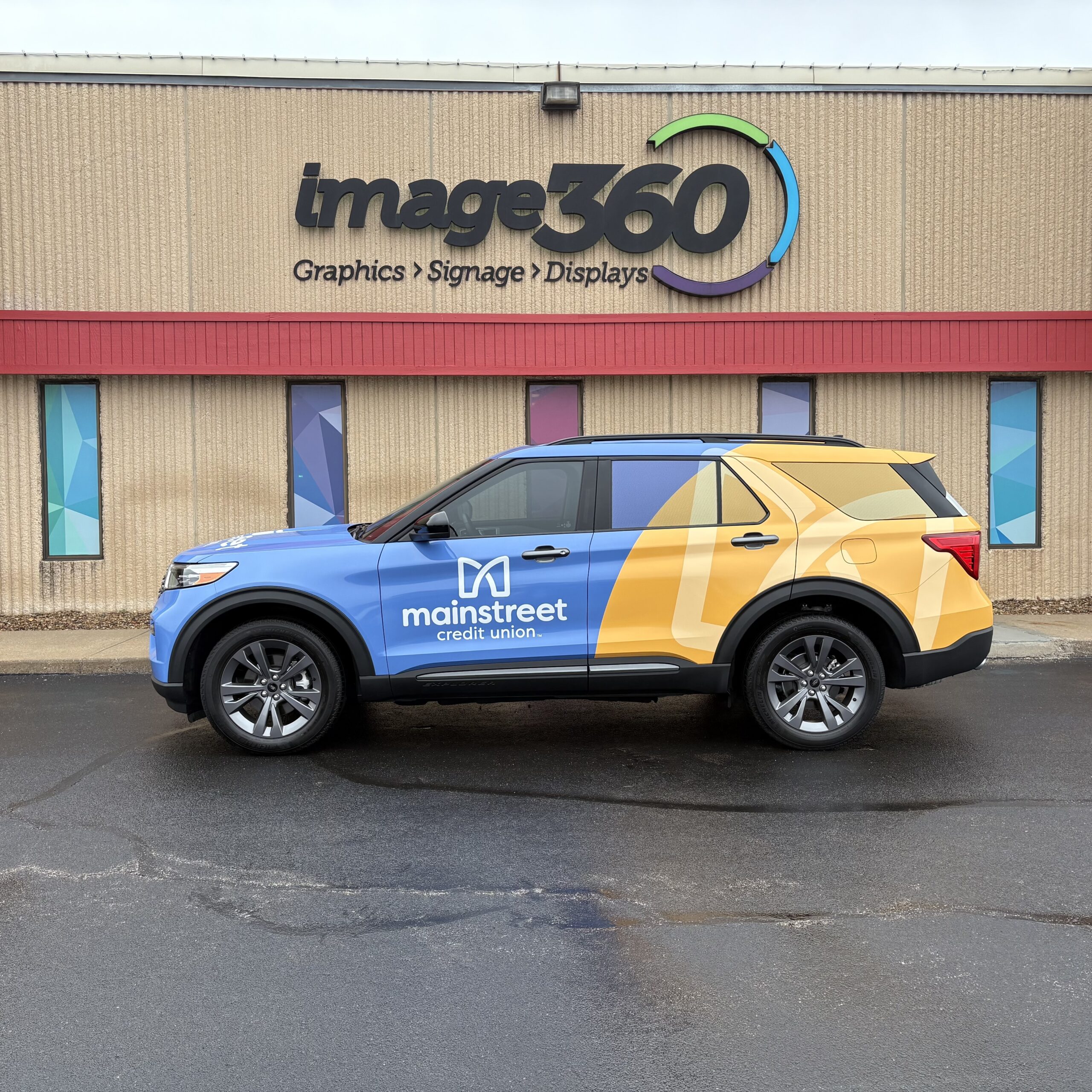 Blue and yellow full vehicle wrap on a Mainstreet Credit Union SUV in Kansas City