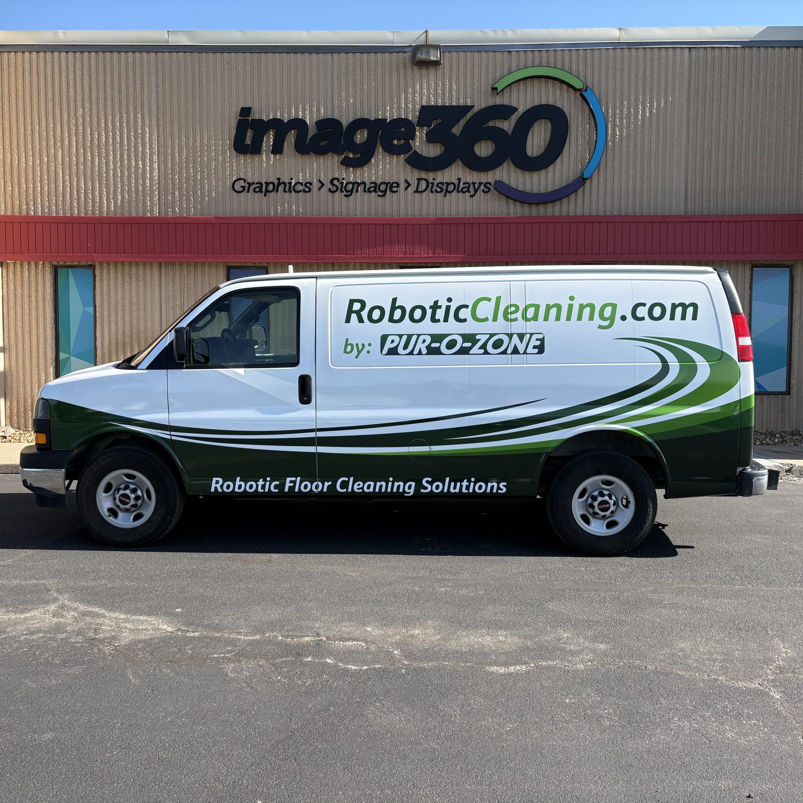 Green and white partial vehicle wrap on a Pur-O-Zone RoboticCleaning.com cargo van in Kansas City